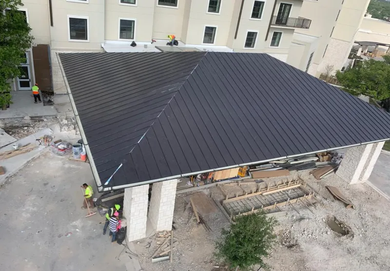 Metal roofing installation team working on a commercial building in Treasure Island